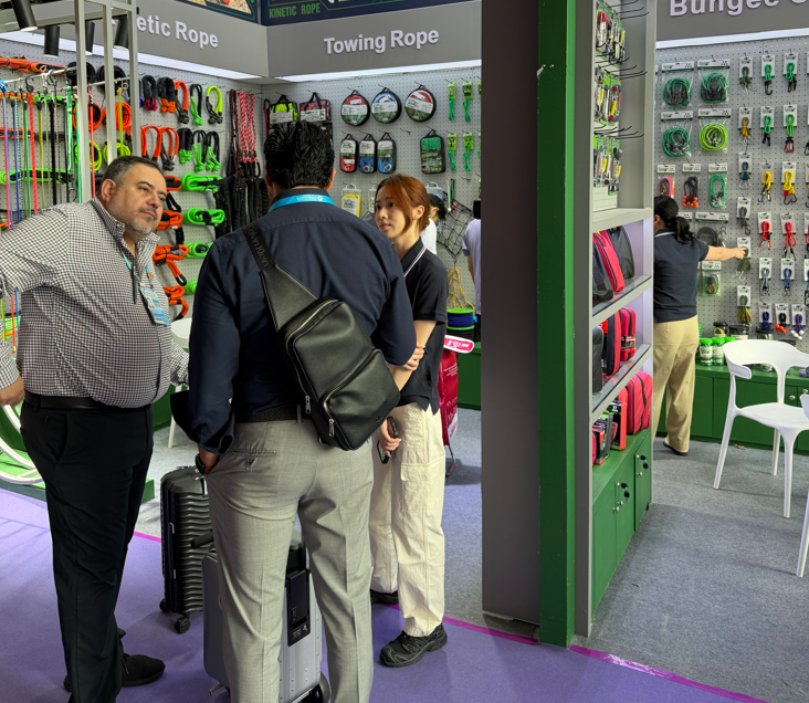 Visitors at the towing rope and bungee cord section of the ALLROAD booth